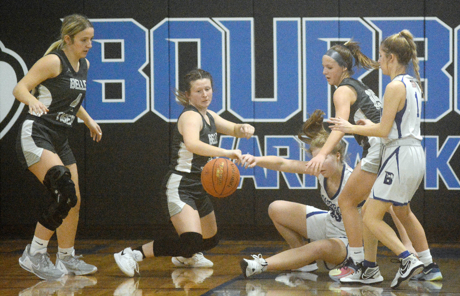 A scramble for a loose ball ensued during Gasconade Valley Conference (GVC) girls basketball action last Wednesday night in Bourbon between Belle’s Lady Tigers and the host Lady Warhawks. Lady Tigers shown (above, from left) include Miranda Sanders, Molly Busch and Anastyn Lansford. Belle will wrap up the 2022 portion of their season tonight (Wednesday) in a Highway 28 showdown at Dixon against the Lady Bulldogs.